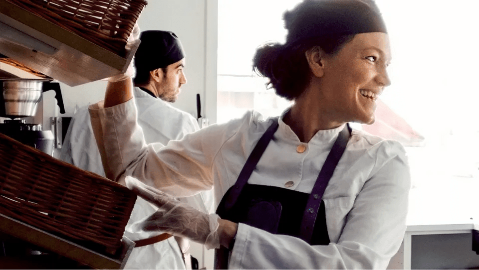 A woman in her forties smiling while at work. She’s happier because she’s fitting easier diabetes management in his busy life with a virtual program.